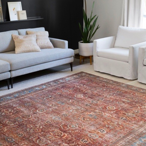 Area rug on carpeted floor | Carpetland USA