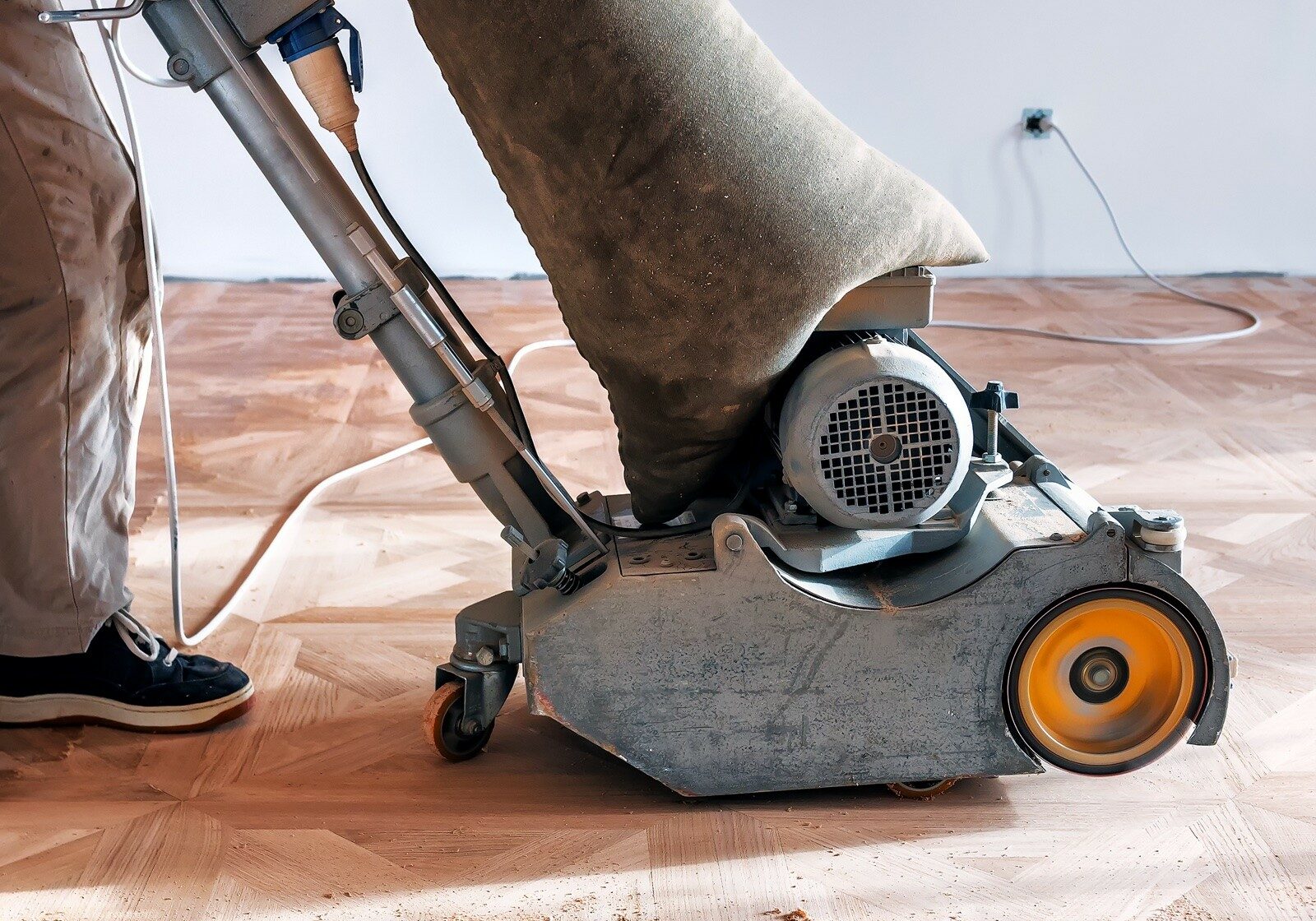 A sander on hardwood flooring | Carpetland USA