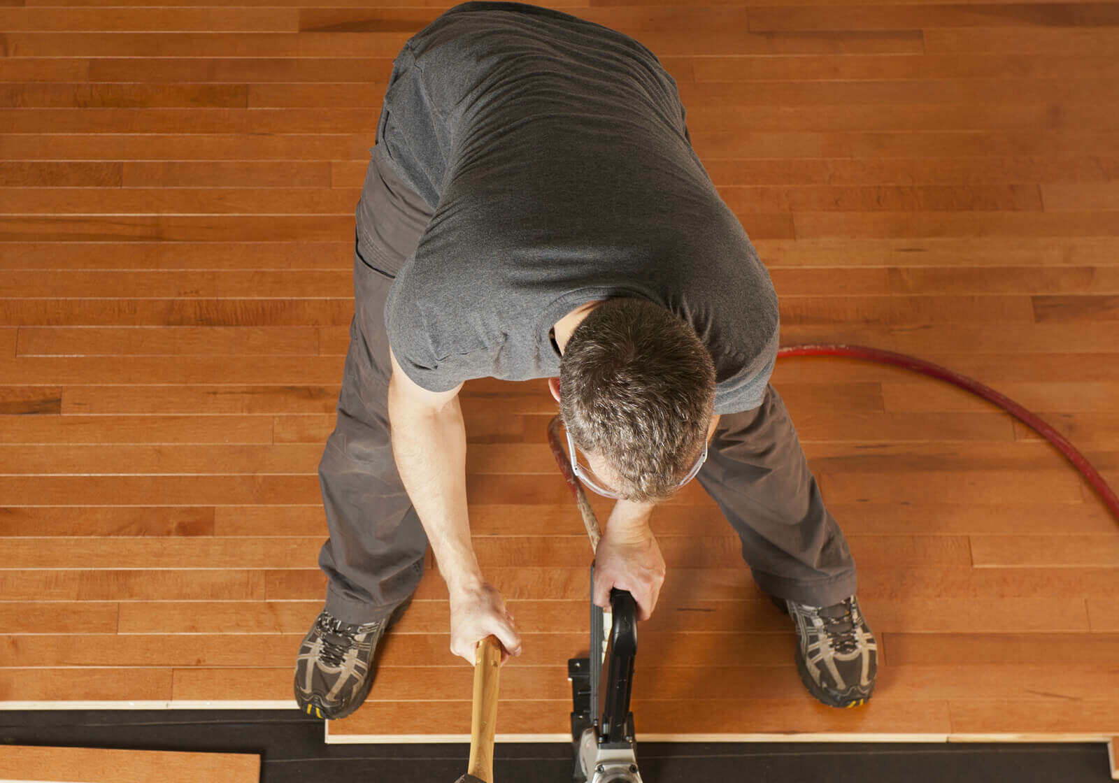 Man installing hardwood | Carpetland USA