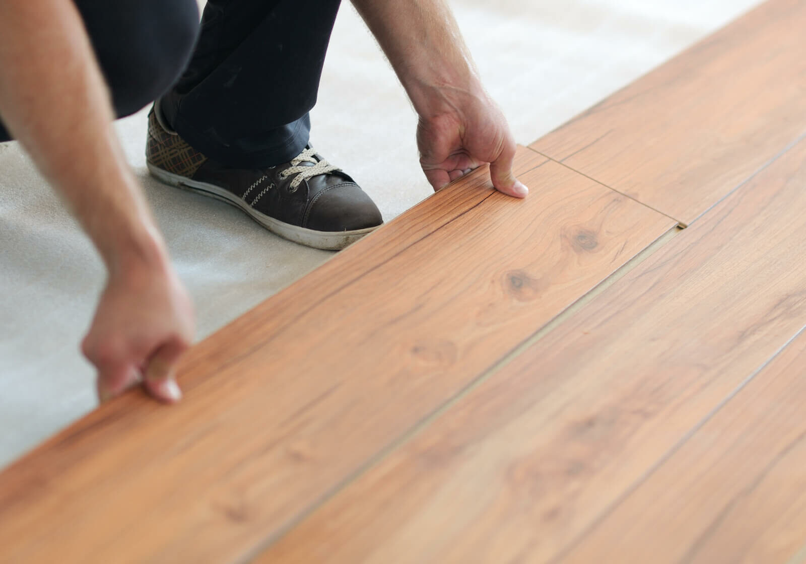 Man installing vinyl flooring | Carpetland USA