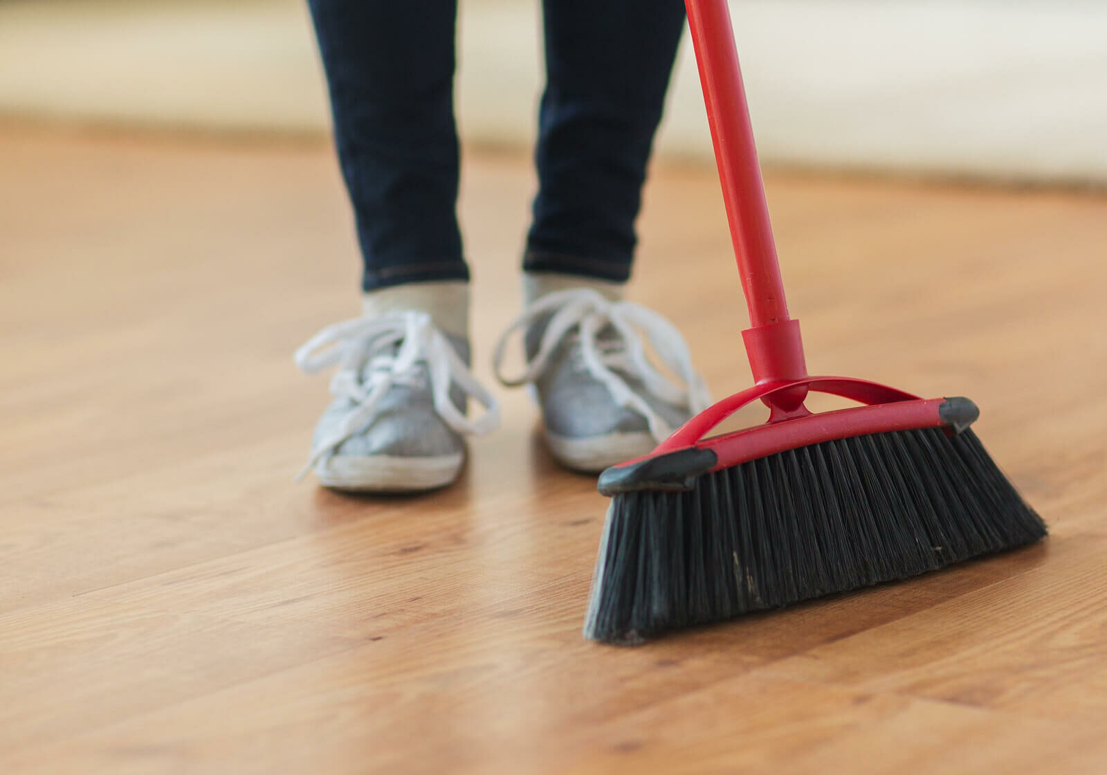 Floor being cleaned with a broom | Carpetland USA